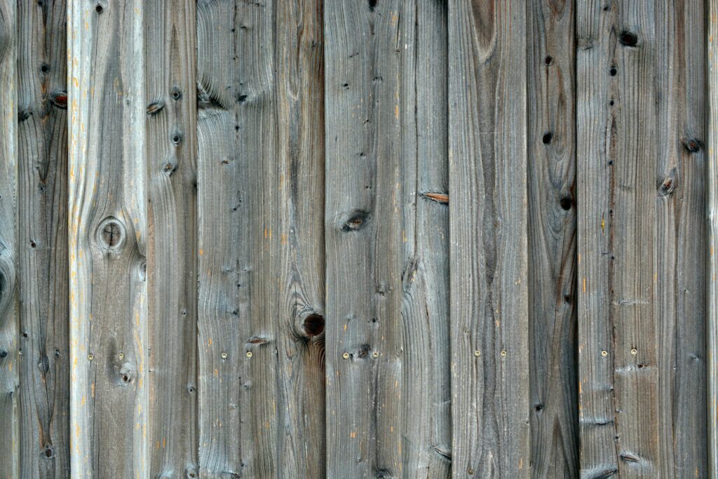 Close-up of a rustic wooden plank wall with weathered texture and natural grain.